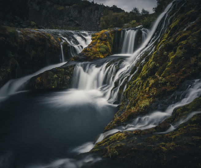 Gjáin natural water pool and waterfall