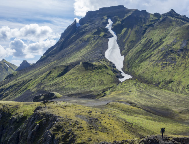 hiker in rocky mossy mountain