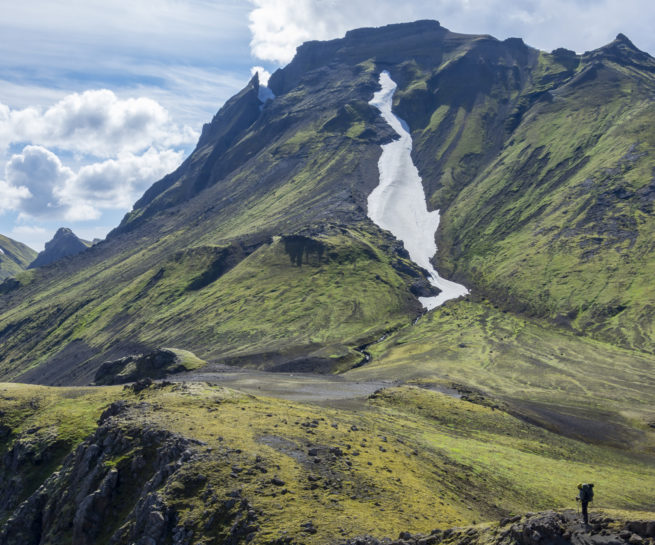hiker in rocky mossy mountain